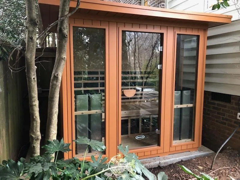 Donohue: A modular infrared sauna positioned beside a swimming pool and fire pit.