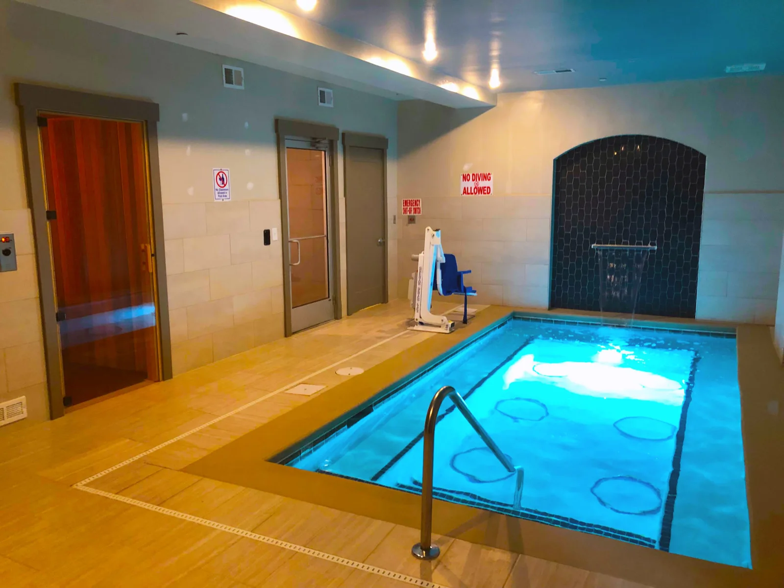 Pinehurst: A spacious commercial sauna in an upscale apartment community, warmed by a floor-standing lava-rock heater.